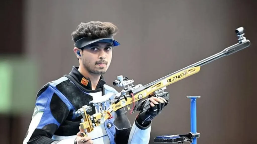 shooting gun, earbuds , cap , blue and black jacket