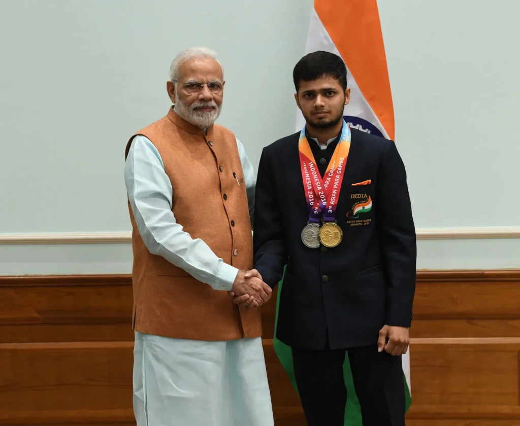 Manish Narwal: A New Champion in Paralympic Shooting , Narendra modi , medals , gold , silver , handshake , black suit